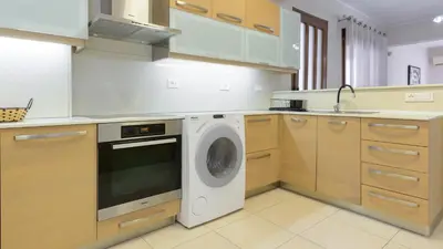 a kitchen with a washing machine and a sink at Harmony House in Faliraki