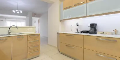 a kitchen with wooden cabinets and a sink at Harmony House in Faliraki