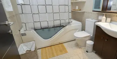 a bathroom with a tub next to a toilet and a sink at Harmony House in Faliraki