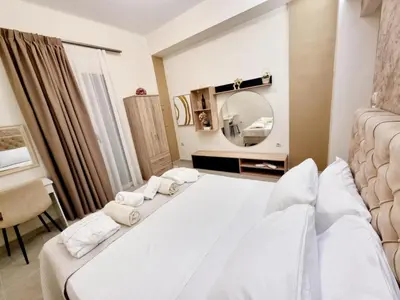 a bedroom with two white beds and a mirror at Rhodes Port Stories in Rhodes Town