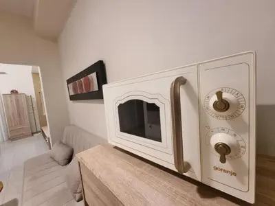 a living room with a tv on the wall at Rhodes Port Stories in Rhodes Town