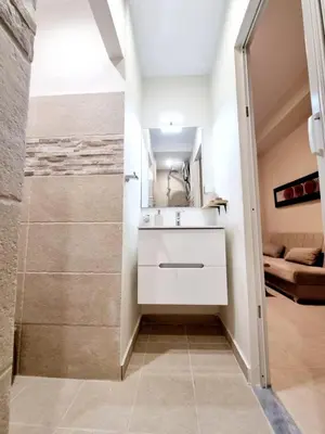 a bathroom with a shower and a sink and a mirror at Rhodes Port Stories in Rhodes Town
