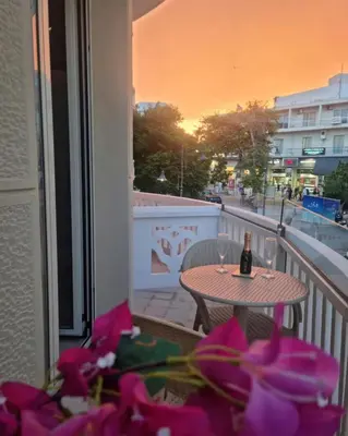 a table on a balcony with a bottle of wine at Rhodes Port Stories in Rhodes Town