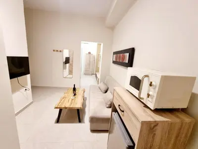 a living room with a couch and a microwave at Rhodes Port Stories in Rhodes Town