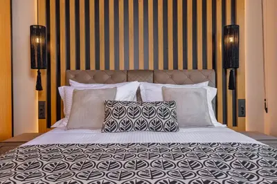 a large bed with two pillows on top of it at Costas Luxury Villas - Costa's Villa in Koskinou