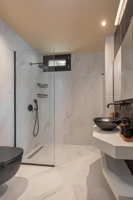 a bathroom with a shower and a toilet and a sink at Costas Luxury Villas - Costa's Villa in Koskinou