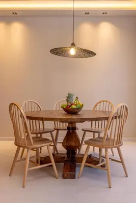 a wooden table with chairs and a bowl of fruit on it at Costas Luxury Villas - Costa's Villa in Koskinou