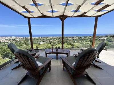 a patio with chairs and a table with a view at Aelios Petra sea view apartment 4 in Asgourou
