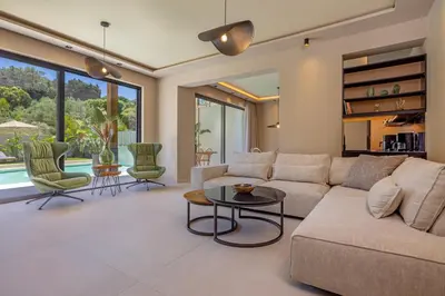 a living room with a couch and a table at Costas Luxury Villas - Athena's Villa in Koskinou