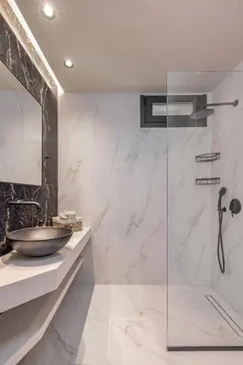 a bathroom with a sink and a shower at Costas Luxury Villas - Athena's Villa in Koskinou