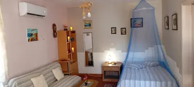 a bedroom with a bed with a blue canopy at Giannis Valeria in Rhodes Town