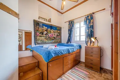 a bedroom with a bed and a painting on the wall at Casa La Perla - Lachania in Lachania