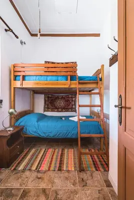 a bedroom with two bunk beds in a room at Casa La Perla - Lachania in Lachania
