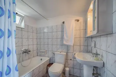 a bathroom with a toilet and a sink and a tub at Casa La Perla - Lachania in Lachania