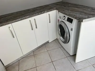 a white laundry room with a washer and dryer at Cozy Kolonaki Retreat in Kremasti