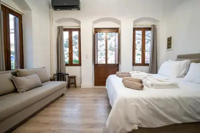 a living room with two beds and a couch at La Casa di Symi - Central Apartment with View in Symi