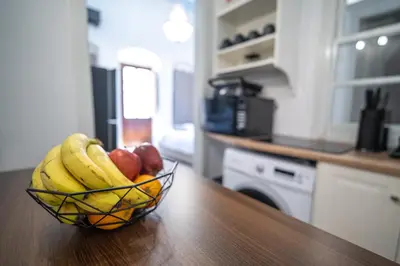 a bowl of fruit on a counter in a kitchen at La Casa di Symi - Central Apartment with View in Symi