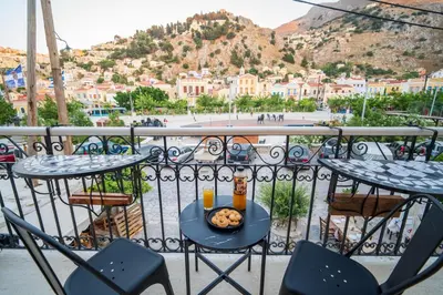 a plate of food on a table on a balcony at La Casa di Symi - Central Apartment with View in Symi