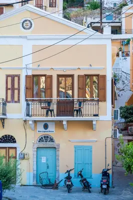 a group of scooters parked outside of a building at La Casa di Symi - Central Apartment with View in Symi