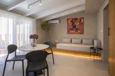 a living room with a table and chairs and a couch at New Town Deluxe Loft in Rhodes Town