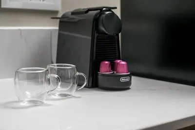 two empty glasses on a counter next to a coffee maker at New Town Deluxe Loft in Rhodes Town