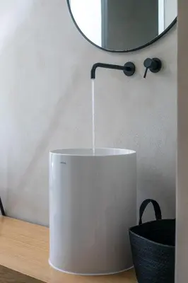 a bottle of water is pouring out of a mirror at New Town Deluxe Loft in Rhodes Town