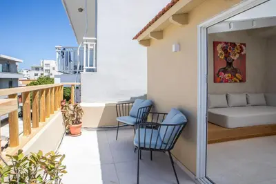 a balcony with two chairs and a couch at New Town Deluxe Loft in Rhodes Town