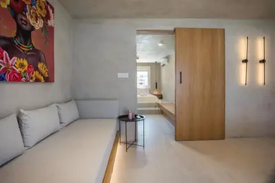a living room with a couch and a table at New Town Deluxe Loft in Rhodes Town