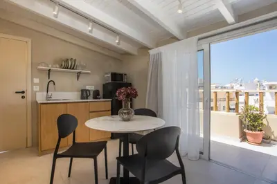 a kitchen and dining room with a table and chairs at New Town Deluxe Loft in Rhodes Town
