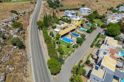 an aerial view of a city with houses and a road at Calypso Lindia Luxury Villa in Líndos