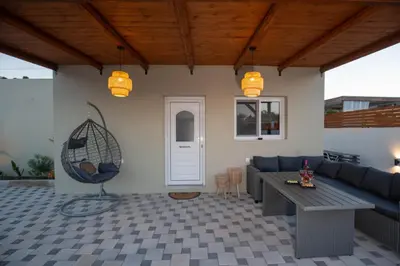 a living room with a couch and a table at Garden Olive Luxury Villa in Archangelos