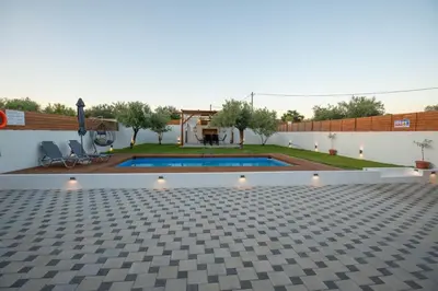 a courtyard with a swimming pool in a house at Garden Olive Luxury Villa in Archangelos