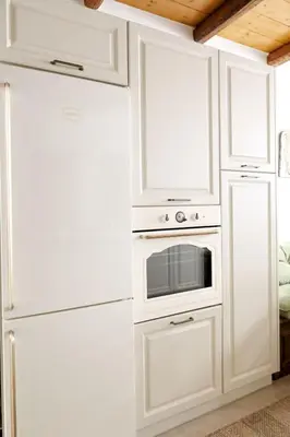 a white kitchen with a microwave and a refrigerator at White Memories boutique home - Romantic Stay in Rhodes in Afantou