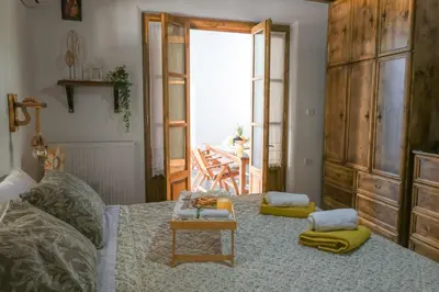 a room with a bed with a table and aoire at White Memories boutique home - Romantic Stay in Rhodes in Afantou