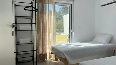 a bedroom with a bed and a ladder next to a window at Radiki in Gennadi