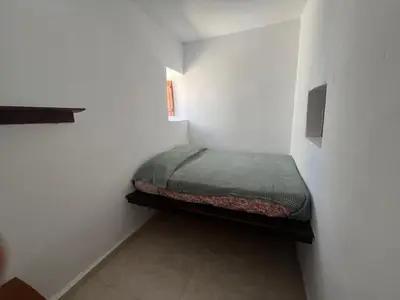 a small bedroom with a bed in a white room at Gennadi Sunrise in Gennadi