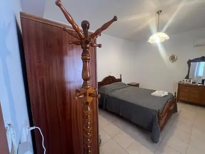 a bedroom with a bed and a wooden pole at Gennadi Sunrise in Gennadi