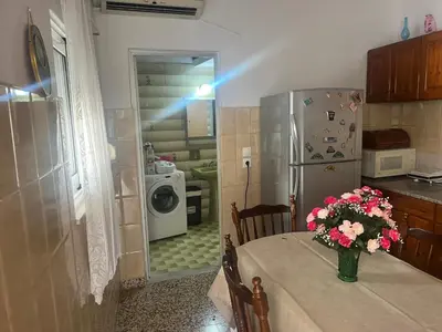 a kitchen with a table with a vase of flowers on it at Gennadi Sunrise in Gennadi