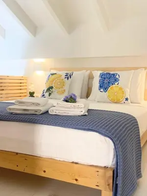 a bedroom with a bed with towels and pillows at ALEMINAS House 2 in Symi