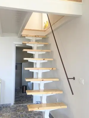 a staircase in a house with wooden steps at ALEMINAS House 2 in Symi