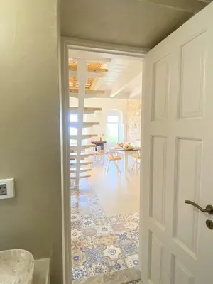 a door leading into a room with a dining room at ALEMINAS House 2 in Symi