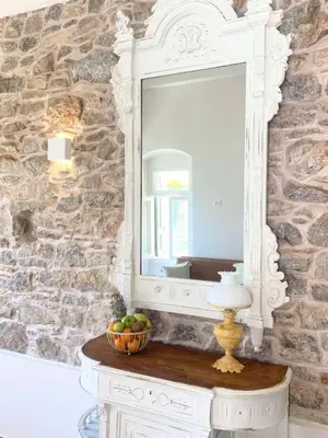 a mirror on a table with a bowl of fruit at ALEMINAS House 2 in Symi