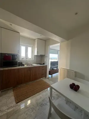 a kitchen with a table and a counter top at Rodos Suites on the Park in Rhodes Town