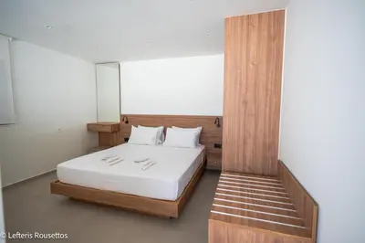 a bedroom with a bed with white sheets and white pillows at Rodos Suites on the Park in Rhodes Town