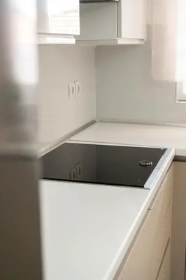 a kitchen with a stove top oven sitting on a counter at Seabreeze By Ro in Rhodes Town