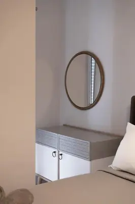 a mirror above a dresser in a bedroom at Seabreeze By Ro in Rhodes Town
