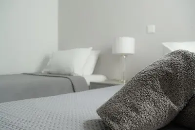 a bedroom with a bed with a blanket on it at Seabreeze By Ro in Rhodes Town