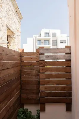 a wooden fence in front of a building at Seabreeze By Ro in Rhodes Town