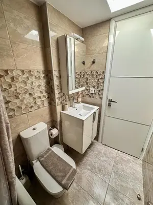a bathroom with a toilet and a sink and a shower at Seabreeze By Ro in Rhodes Town