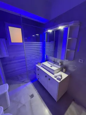 a bathroom with a white sink and a mirror at ELMA apartment 2 Kremasti in Kremasti